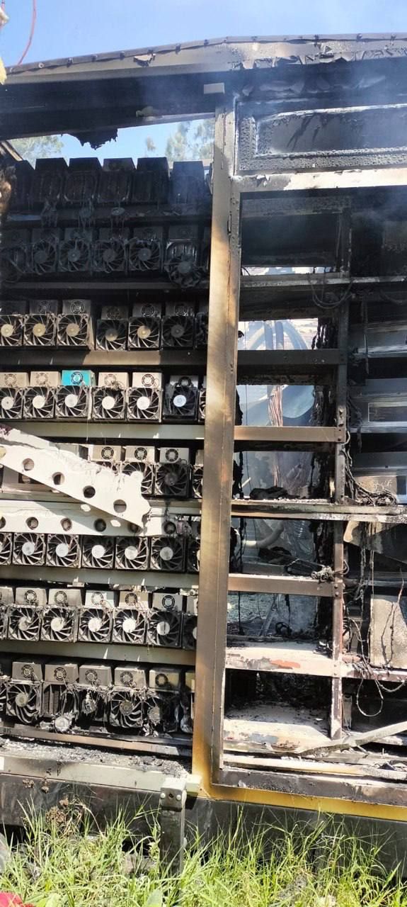 Fire-damaged mining container with scorched shelves