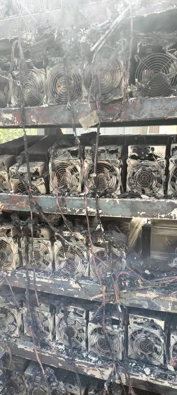 Charred miners on metal shelves